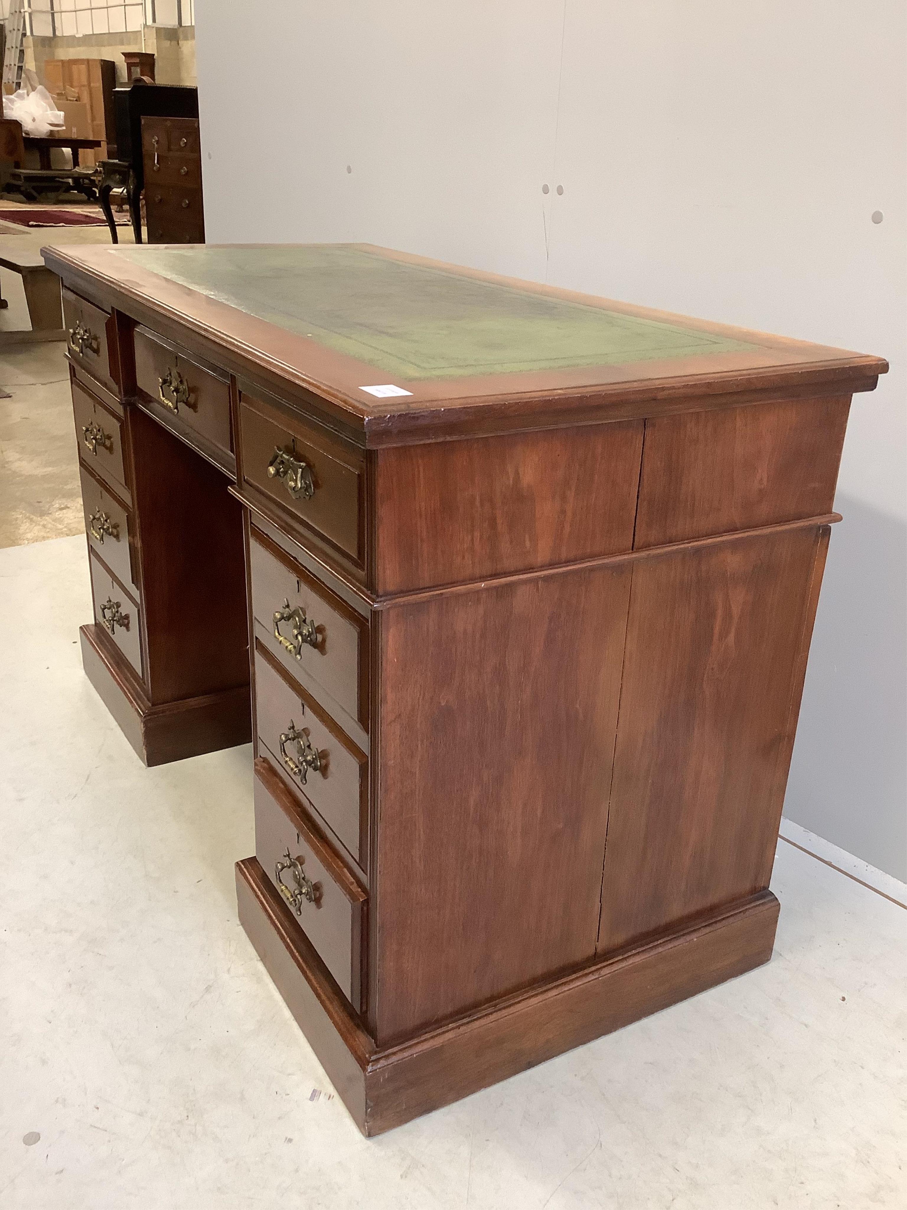 A late Victorian mahogany kneehole pedestal desk, fitted nine small drawers, width 121cm, depth 59cm, height 77cm. Condition - fair to good